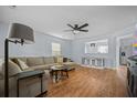 Cozy living room with hardwood floors, a comfortable sofa, and a modern ceiling fan at 521 Holiday Dr, Summerville, SC 29483