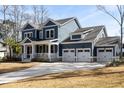 Beautiful two-story home with a three-car garage and a covered porch, perfect for enjoying the outdoors at 5680 Barbary Coast Rd, Hollywood, SC 29449