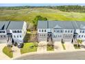 An aerial view of the townhome community showcasing well-manicured lawns and gray roofs at 591 Mclernon Trace, Johns Island, SC 29455