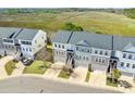 An aerial view of the community, near the marsh, showcasing its gray roofs and pleasant surroundings at 591 Mclernon Trace, Johns Island, SC 29455