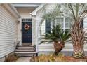 Inviting front entrance with a charming floral wreath and a well-manicured yard at 642 Bridlewood Ln, Mount Pleasant, SC 29466