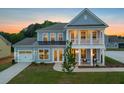 Charming two-story home with light blue siding, a covered porch and manicured lawn at 742 Maynard Ln, Summerville, SC 29486