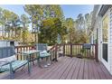 Relaxing back deck featuring a patio table with seating and overlooking a wooded backyard at 754 Miriam Ln, Ridgeville, SC 29472