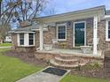 Inviting front porch with classic brick stairs, white chairs, and a covered entrance at 760 Royle Rd, Ladson, SC 29456