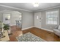 Cozy living room with hardwood floors, gray walls, natural light and an open view to the dining area at 760 Royle Rd, Ladson, SC 29456