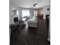 Spacious living room with fireplace, ceiling fan, and dark wood flooring at 7955 Timbercreek Ln # 1807, North Charleston, SC 29418