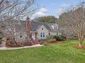 Inviting two-story home with manicured lawn, mature trees, and red brick chimney in a desirable neighborhood at 95 Plymouth Ave, Charleston, SC 29412