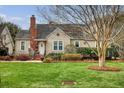 Well-maintained two-story home with lush front yard, mature landscaping, and classic architectural details at 95 Plymouth Ave, Charleston, SC 29412