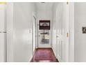 Bright hallway with white walls, wood flooring, and a clear view to the front door at 101 Danzid Dr, Summerville, SC 29483