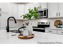 Bright kitchen featuring white cabinets, stainless steel appliances, and quartz countertops at 1020 Drakeford St # 9P, Saint George, SC 29477