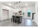 Modern kitchen with stainless steel appliances, white cabinets, gray flooring and an island with seating at 1020 Drakeford St # 9P, Saint George, SC 29477