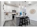 Modern kitchen with stainless steel appliances, white cabinets, gray flooring and an island with seating at 1020 Drakeford St # 9P, Saint George, SC 29477