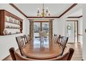 Elegant dining room with a large wooden table, decorative shelving, and stylish window treatments at 103 Night Hawk Ln, Summerville, SC 29485