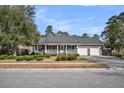 Charming brick home features an inviting front porch and an attached two-car garage at 103 Night Hawk Ln, Summerville, SC 29485