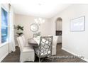 Cozy dining room with a round table, elegant chairs, and natural light from the window at 1044 Northern Flicker Dr # Cc3-18-2P, Ravenel, SC 29470