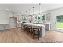 Spacious kitchen with grey cabinets, a large island with seating, and stainless steel appliances at 1047 House Finch Ave # Cc3-19-2P, Ravenel, SC 29470
