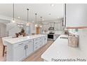 Modern kitchen featuring a large island, quartz countertops, stainless steel appliances, and pendant lighting at 1047 House Finch Ave # Cc3-19-2P, Ravenel, SC 29470