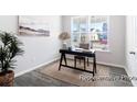 Cozy home office featuring a desk, chair, rug and natural light from the large windows overlooking the front yard at 1050 Marsh Harrier Dr # Cc3-15-3P, Ravenel, SC 29470