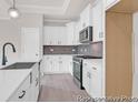 Modern kitchen with stainless steel appliances, white cabinets, and dark hardware at 1056 Marsh Harrier Dr # Cc3-15-6P, Ravenel, SC 29470