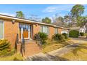 Charming single-story brick home with a well-manicured lawn and mature landscaping at 1060 Yeamans Hall Rd, Hanahan, SC 29410