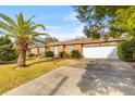 Classic brick home featuring an attached two-car garage and mature palm tree at 1060 Yeamans Hall Rd, Hanahan, SC 29410