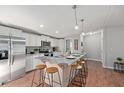 Modern kitchen featuring a large island with seating, stainless steel appliances, and wood-look floors at 122 Liferidge Ct, Moncks Corner, SC 29461