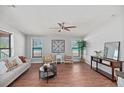 Bright living room showcasing hardwood floors, a ceiling fan, and neutral décor, creating a cozy atmosphere at 122 Liferidge Ct, Moncks Corner, SC 29461