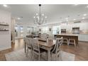 Open floor plan showcases the dining area with a stylish chandelier, seamlessly connecting to the kitchen and living room at 125 Leeward Landing, Summerville, SC 29486