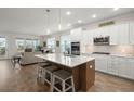 Modern, open kitchen featuring a spacious island, stainless steel appliances, and hardwood floors at 125 Leeward Landing, Summerville, SC 29486