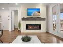 Cozy living room features an electric fireplace, decorative mantel, and access to outdoor patio at 125 Leeward Landing, Summerville, SC 29486