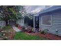 Landscaped backyard with a covered patio, flowers and lush greenery offering a private and peaceful outdoor space at 1310 Pilsdon Crest, Mount Pleasant, SC 29464