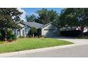 Charming one-story home featuring a well-maintained lawn, mature trees, and an attached two car garage at 1310 Pilsdon Crest, Mount Pleasant, SC 29464