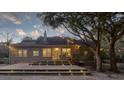 Large backyard with a multi-level deck, string lights, and mature trees adding to the atmosphere at 1365 Whippoorwill Farm Rd, Johns Island, SC 29455