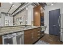 Well-equipped kitchen features granite countertops, stainless steel appliances, and stylish wooden cabinetry at 150 Bee St # 312, Charleston, SC 29401