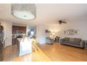 Open floor plan featuring a kitchen island that flows into a living room with light hardwood floors at 1749 Towne St, Johns Island, SC 29455