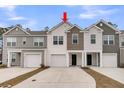 Charming townhomes featuring varied siding colors and attached garages, complemented by concrete driveways and blue skies at 205 Cozy Brook Ct, Summerville, SC 29486