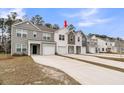 A row of inviting townhomes with varied siding colors, each featuring attached garages and concrete driveways at 205 Cozy Brook Ct, Summerville, SC 29486