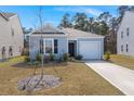 Charming single-story home featuring light blue siding, a one-car garage, and a well-maintained lawn at 229 Coral Sunset Way, Summerville, SC 29486