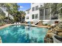 Relaxing pool area with adjacent patio seating, perfect for outdoor entertaining and enjoying the beautiful surroundings at 2745 Oak Manor Dr, Mount Pleasant, SC 29466