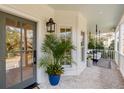 Inviting front porch featuring brick flooring, a swing, a potted plant and stylish decor at 3019 Viscount St, Charleston, SC 29424