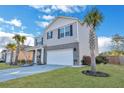 Inviting gray home with tidy landscaping, a spacious two-car garage, and a lush lawn at 302 Willow Pointe Cir, Summerville, SC 29486