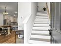 Bright foyer with staircase leading to upper level, adjacent to the open kitchen area at 305 Lanyard St, Johns Island, SC 29455