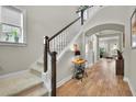 Bright foyer showcasing a staircase, hardwood floors, and stylish decor providing a welcoming entrance at 3676 Shutesbury St, Mount Pleasant, SC 29466