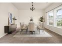 Bright dining room featuring modern chandelier, furniture, and natural light from a large window at 406 Butterfly Bush Dr, Goose Creek, SC 29445