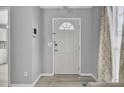 Bright entryway featuring light grey walls, wood-look floors, and a white front door at 4064 Bonaparte Dr, North Charleston, SC 29418