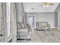 Cozy living room with neutral-toned sofas, rug, and large windows for ample natural light at 4064 Bonaparte Dr, North Charleston, SC 29418