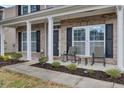 Inviting front porch with rocking chairs and brick facade at 518 Mountain Laurel Cir, Goose Creek, SC 29445