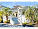Stunning white brick house with a grand entrance and a picturesque, turret-style covered porch perfect for relaxation at 54 Gibbes St, Charleston, SC 29401