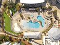 Overhead shot of luxurious resort pool with plenty of seating, palm trees, and well-maintained landscaping at 5802 Palmetto Dr # B-202, Isle of Palms, SC 29451