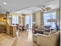 Spacious living area with modern furnishings, wood floors, large windows, and an open floor plan at 5802 Palmetto Dr # B-202, Isle of Palms, SC 29451